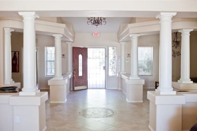 Bright lobby area with columns and a front door