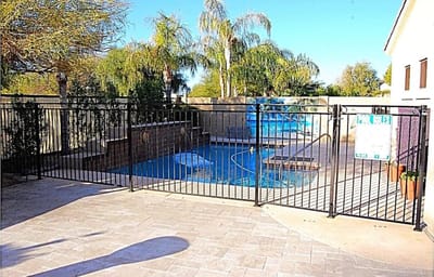 Outdoor pool area with fenced enclosure