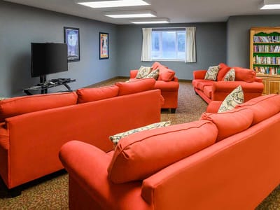 Common area with red couches and TV