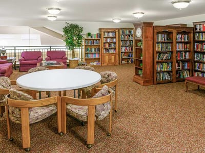 Cozy library area with seating and bookshelves
