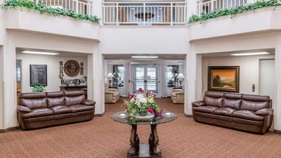 Common area with seating and decor in a senior living facility.