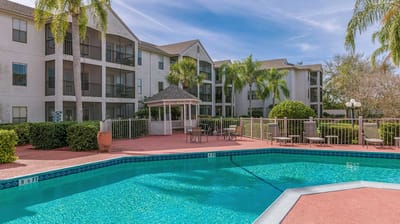 Outdoor pool area with building in the background