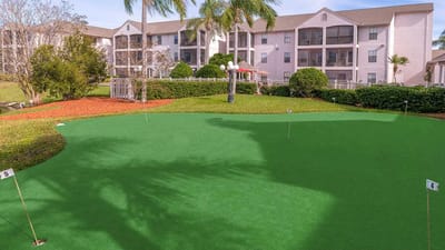 Outdoor putting green with the facility's building in the background