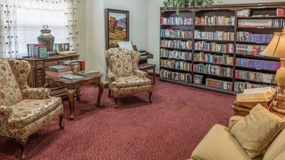 Cozy library area with seating and bookshelves