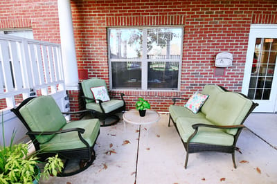 Seating area with green chairs and a small table