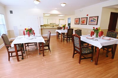 Dining room set for a meal with floral centerpieces
