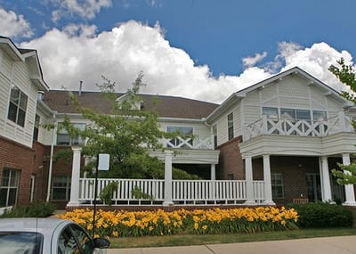 Exterior view of a senior living facility with flowers