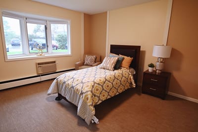 A private room with a bed and seating area