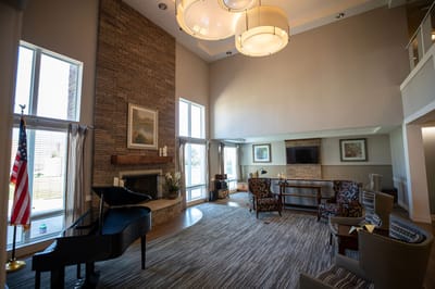 Interior view of a common area with seating and piano