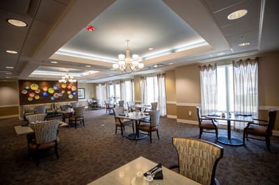 Dining area with tables and chairs in a bright room