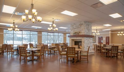 Bright dining room with tables and a fireplace