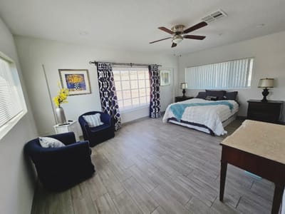 Comfortable interior of a resident room with bed and seating