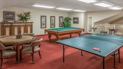 Interior view of a recreational room with pool and ping pong tables