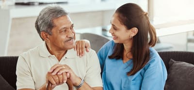 Caregiver interacting warmly with senior resident.