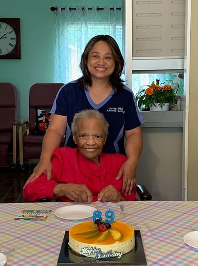Resident celebrating birthday with staff member.