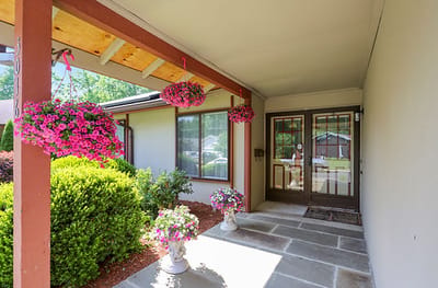 Welcoming entrance with hanging flower pots