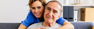 Caregiver with a smiling senior resident