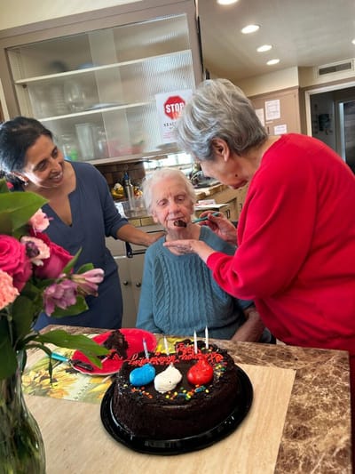 Residents celebrating with a cake and candles
