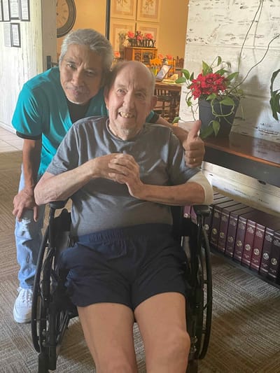Caregiver and resident smiling in a common area