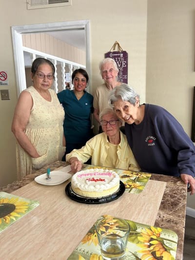 Residents celebrating with a cake for a birthday