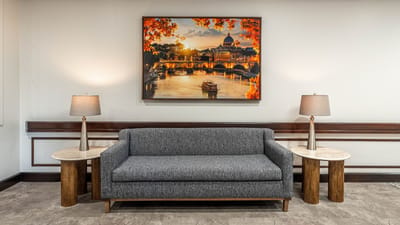 Interior lounge area with a grey couch and art