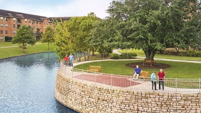 Residents enjoying a peaceful outdoor space by the water