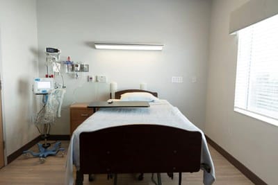 Private resident room with a bed and medical equipment