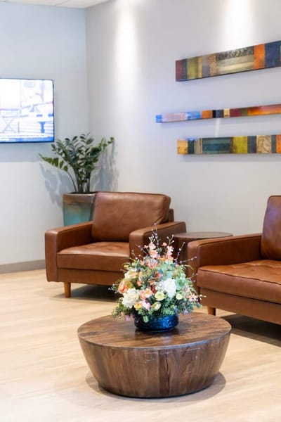 Bright common area with seating and floral arrangement