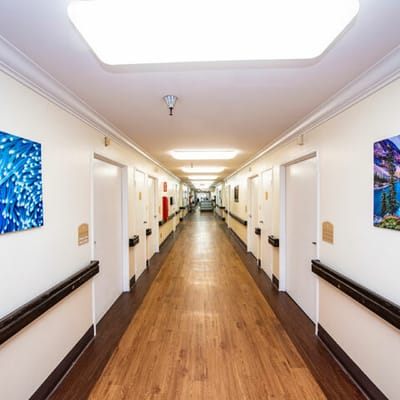 Brightly lit hallway with colorful artwork on the walls