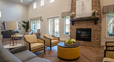 Bright common area with seating and fireplace