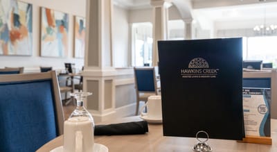 Dining area with menu and glassware set on the table