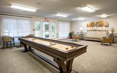 Interior common area with a shuffleboard table