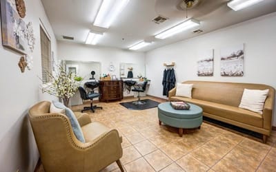 Bright salon area with seating and beauty stations