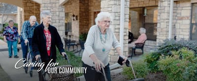 Residents enjoying a walk outside the facility