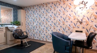 Modern hair salon area with floral wallpaper