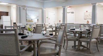 Dining area with tables and chairs set for meals