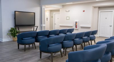 Bright common area with seating and a TV