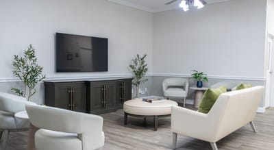 Bright interior common area with seating and TV