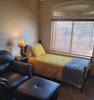 Cozy private resident room with a bed and seating area