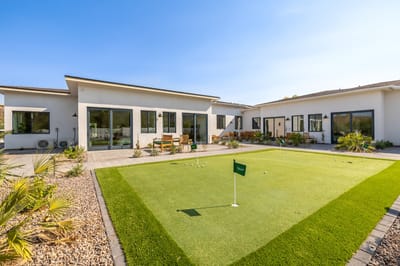 Outdoor space with putting green and seating area
