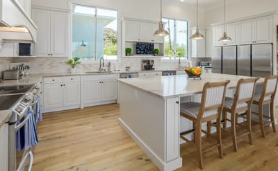 Modern kitchen area with seating and natural light