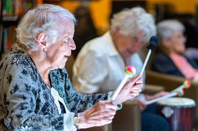 Residents enjoying a music activity in the common area