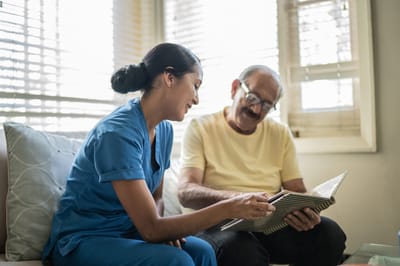 Staff member engaging with a resident in a cozy room