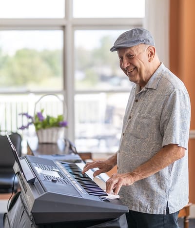 Resident playing keyboard in a common area