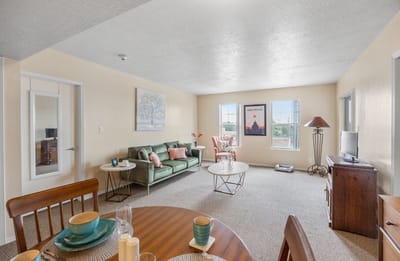 Bright interior of a shared living space with a couch and table