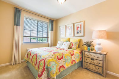 Cozy bedroom in a senior living unit with colorful decor