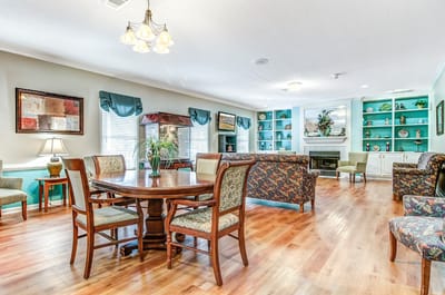Bright common area with seating and a fireplace
