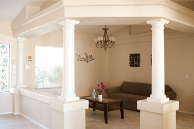 Bright interior common area with a couch and table