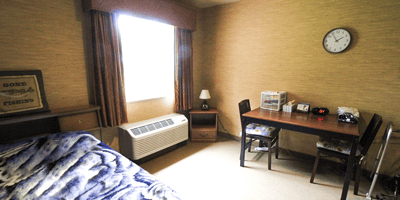 Cozy resident room with a bed and desk area