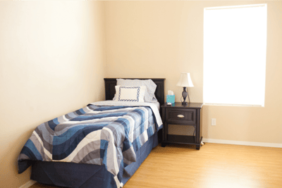 Cozy interior of a resident room with a single bed
